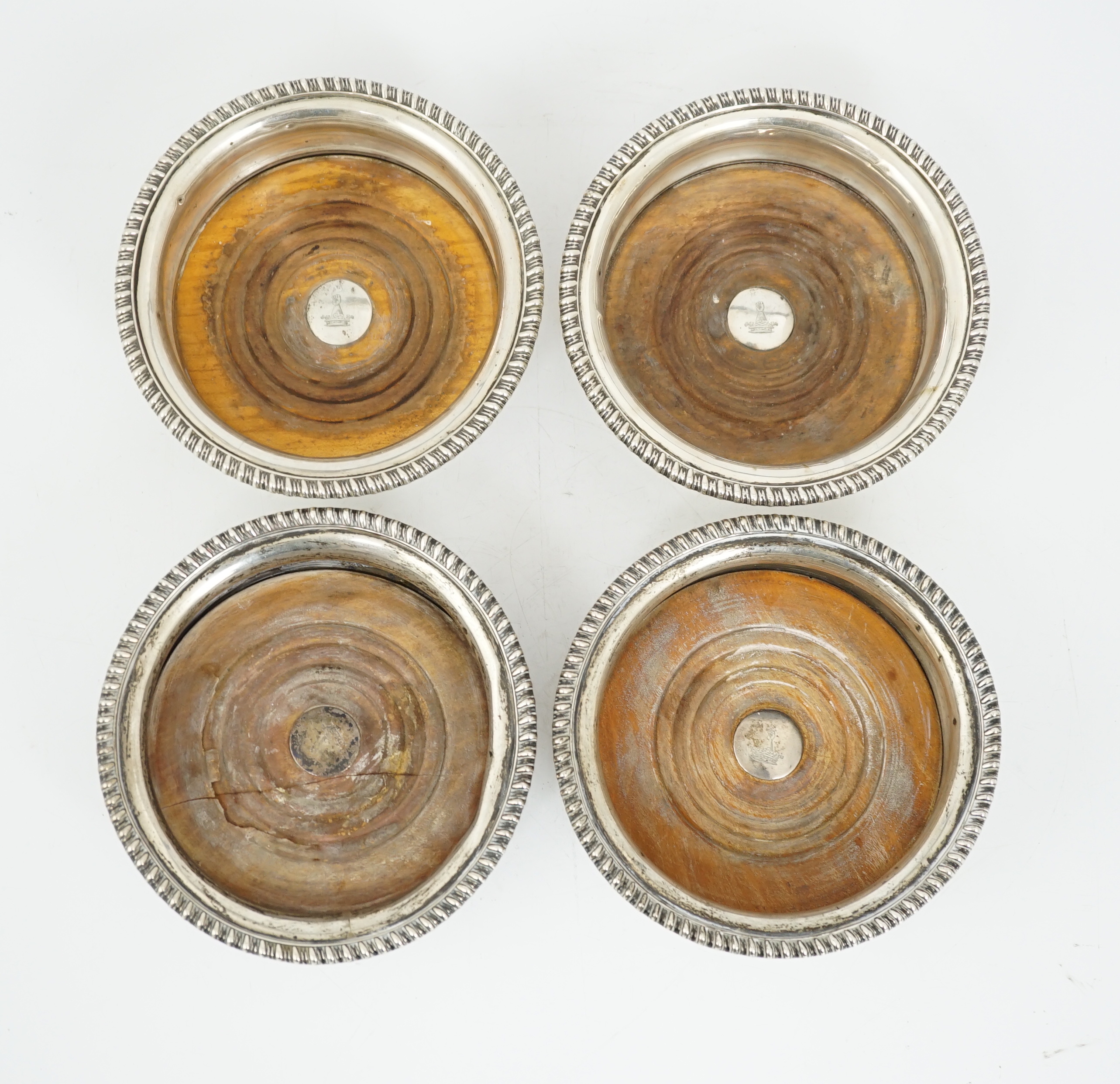 Two pairs of early 19th century silver mounted wine coasters